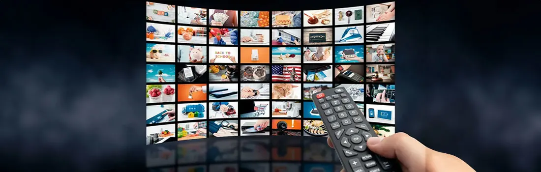 A wall of screens displays diverse content. A hand holds a remote control in the foreground. The background is a dark, cloudy texture.
