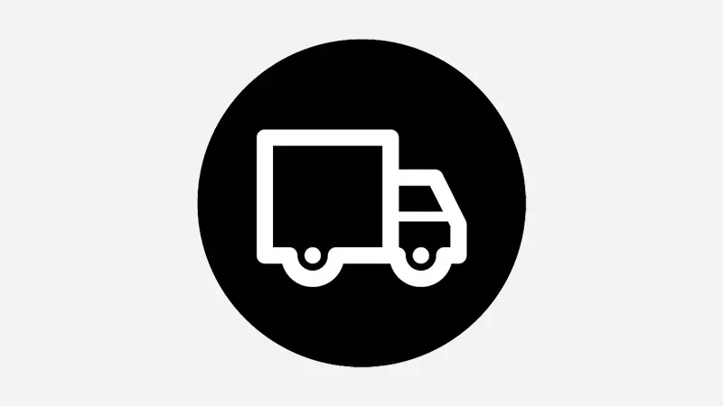 Black circle with white lorry icon, showing delivery vehicle with cargo space for transporting and delivering products to customers.