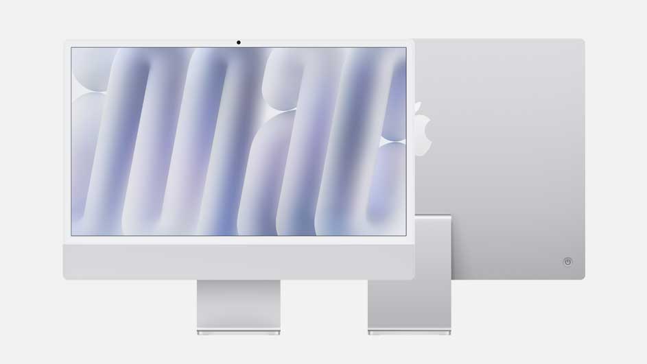 A sleek white desktop computer stands against a light background. Its screen displays soft purple shapes, while the rear panel and supporting stand are clearly visible.
