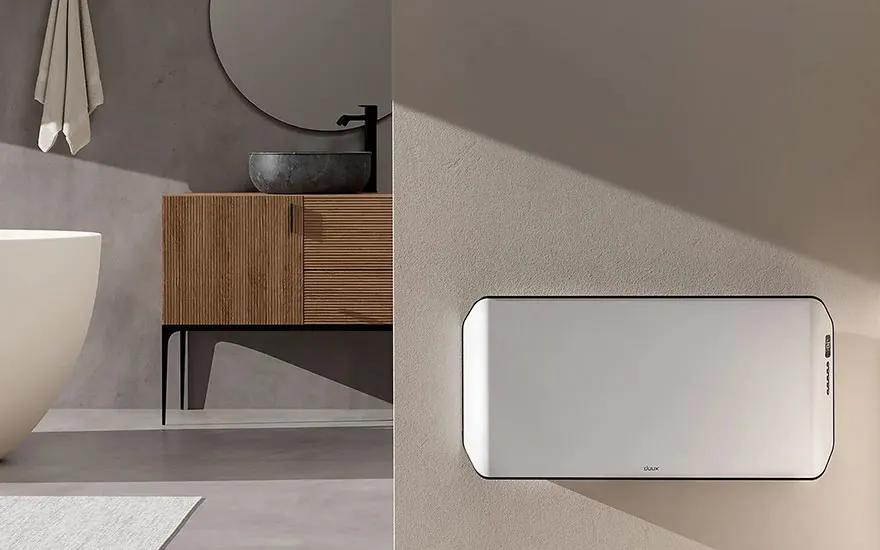 Image d'une salle de bain moderne avec baignoire blanche, meuble en bois, miroir rond et radiateur mural blanc.