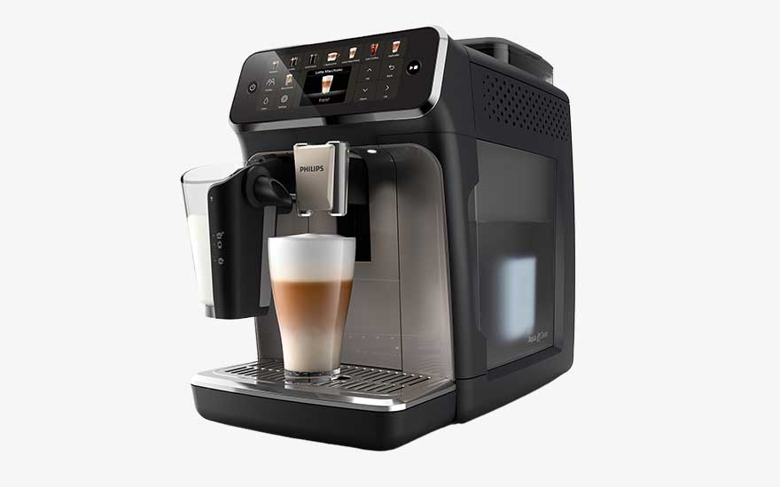A modern Philips espresso machine makes a layered latte in a tall glass, featuring a touchscreen and side milk container.