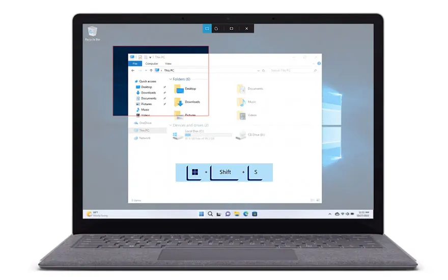 Un ordinateur portable gris affiche des fenêtres de l'explorateur Windows ouvertes sur un écran gris. Le clavier est visible au premier plan.