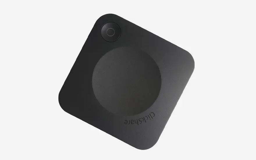 Top view of a single ClickShare base unit with a minimalist design, used for wireless presentation connections.