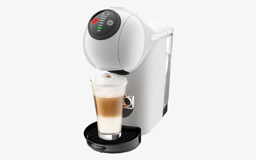 A white Krups coffee machine pours a creamy latte into a tall glass, with round controls and a transparent water reservoir.