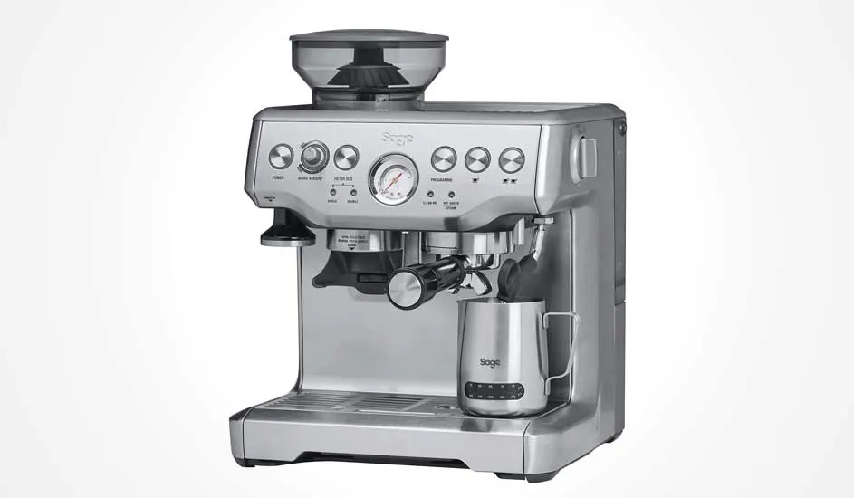 A silver espresso machine is shown against a white background. It has a bean hopper, buttons, a pressure gauge, a portafilter and frothing wand.