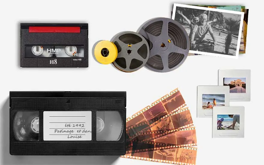 A collection of obsolete media formats, including VHS, film reels, slides, and photo prints on a white background.