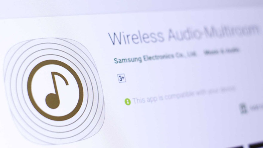 Een schermafbeelding van de app "Wireless Audio Multiroom" met een gouden muzieknoot binnen concentrische cirkels.