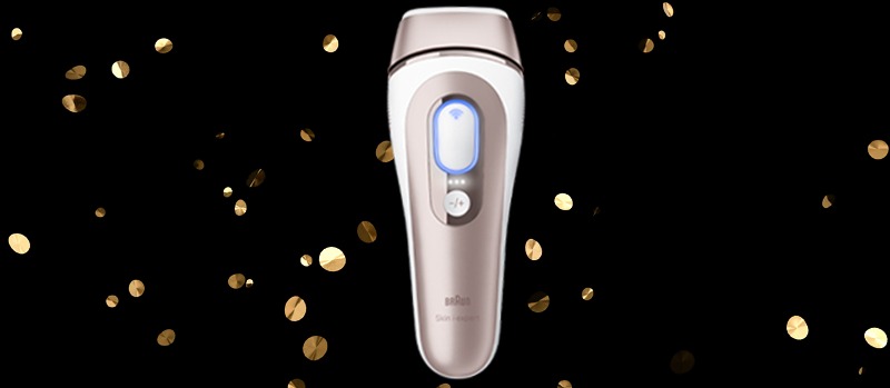 L’image montre un appareil d’épilation Braun avec des accents de couleur or, entouré de confettis dorés sur un fond noir.