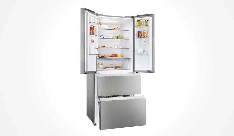 Silver refrigerator with double doors at the top and two drawers at the bottom. Filled with fresh food and bottles, practical and stylish design.
