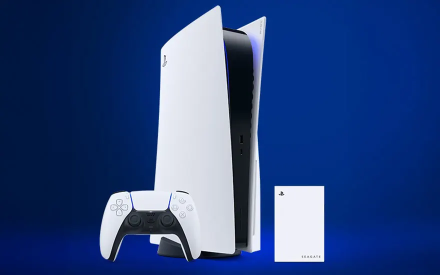 A PS5 is standing upright with a white DualSense controller and a Seagate external hard drive against a blue background.