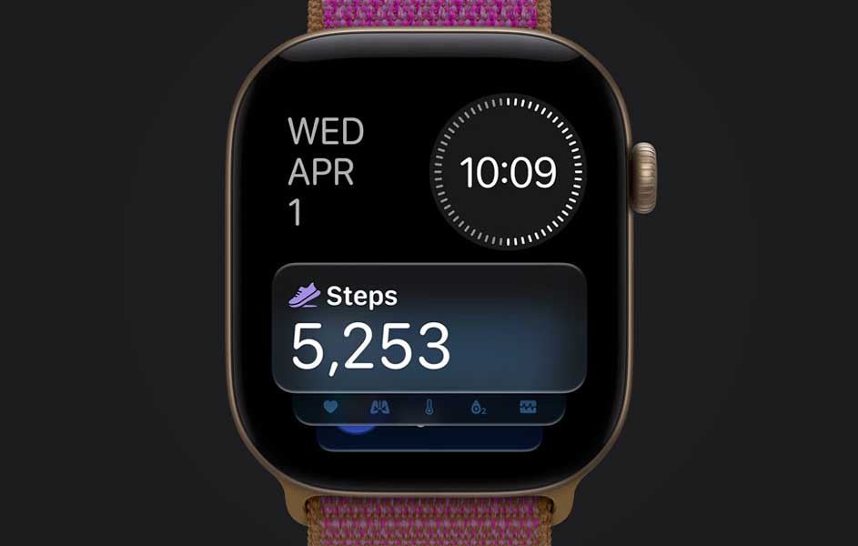 Een smartwatch met een roze gevlochten band staat tegen een donkere achtergrond. Het scherm toont woensdag 1 april, de tijd 10:09 en 5.253 stappen.
