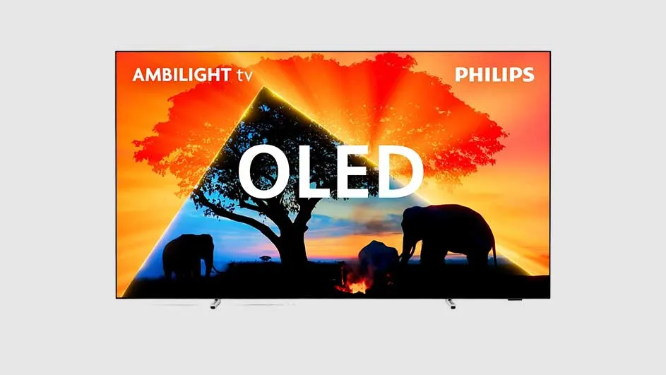 Écran TV OLED Philips affichant une image d'éléphants près d'un arbre au coucher du soleil, avec des logos en haut.