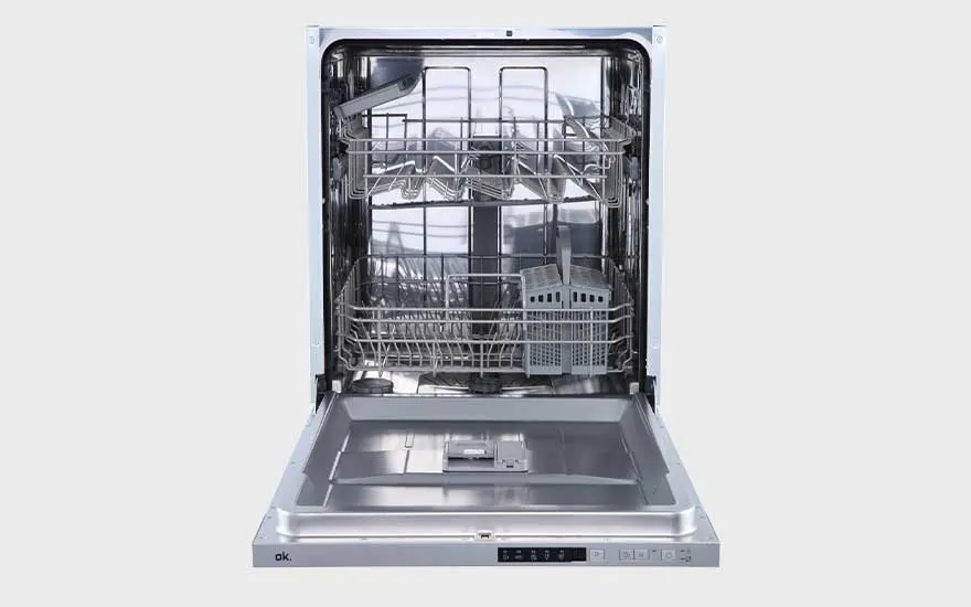 An open dishwasher with two racks and a cutlery basket, completely empty and ready to be loaded in a modern kitchen.