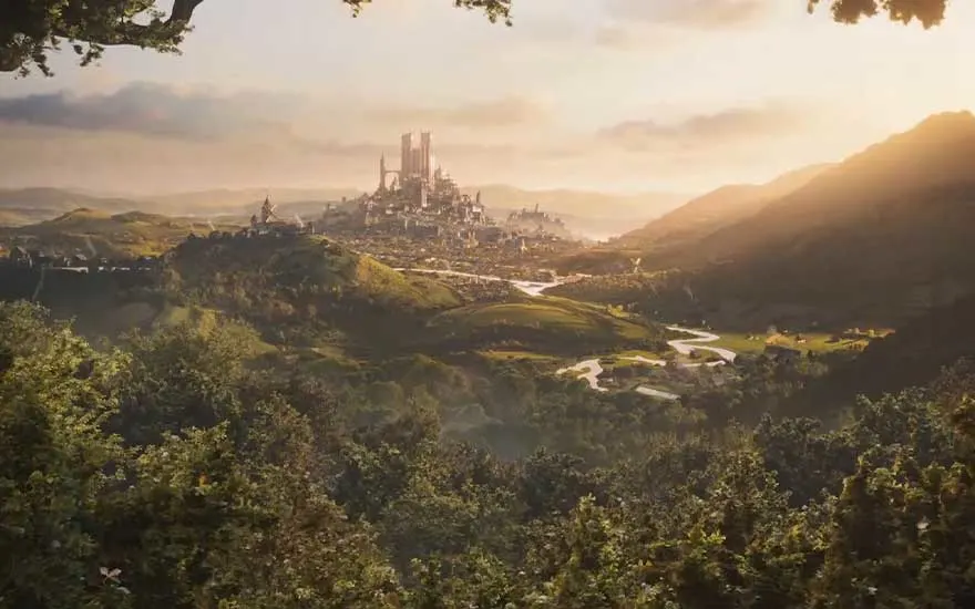 Vast fantasy landscape of green hills, winding river and distant capital city of tall spires, bathed in warm golden sunset light.
