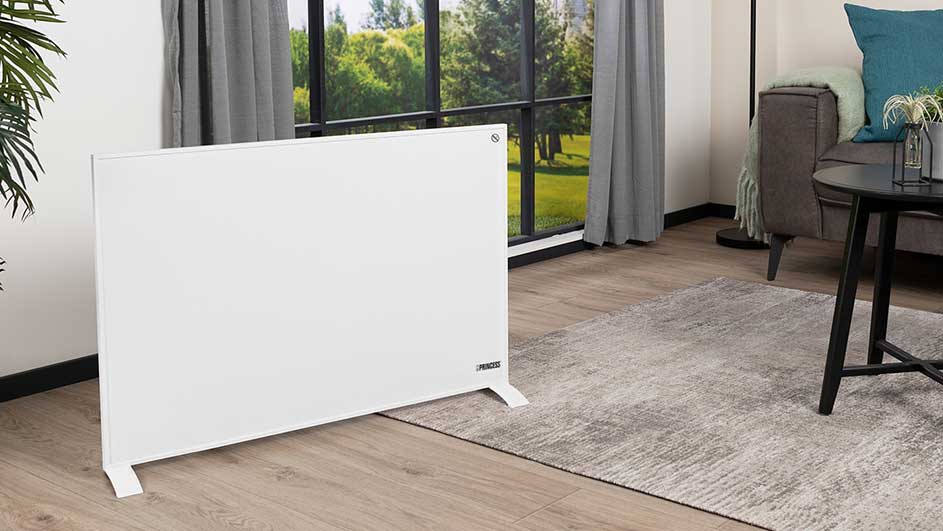 A white radiator stands on a wood floor near a grey rug. A window with grey curtains is in the background.