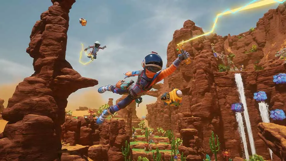 Un paysage de canyon rougeâtre avec des cascades, des plantes colorées et des personnages en vol avec des jetpacks.