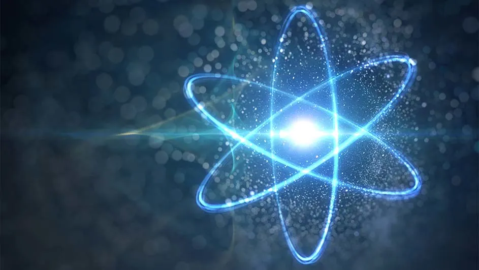 Un atome bleu lumineux avec des orbites sur un fond bleu foncé flou.