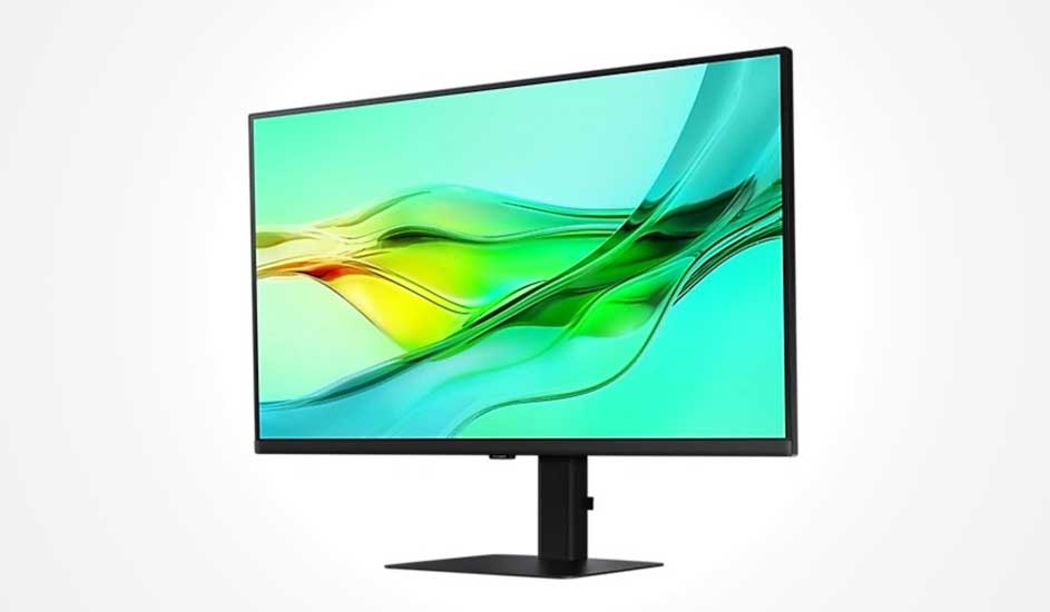 Black monitor with slim bezel displays flowing green and yellow waves on pale blue, resting on a sleek rectangular stand.