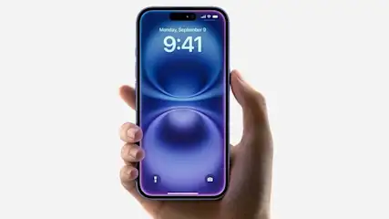 A hand holds an Apple iPhone with a purple display, slim bezels, and a Dynamic Island cut-out. The lock screen shows 9:41 on Monday, September 9.