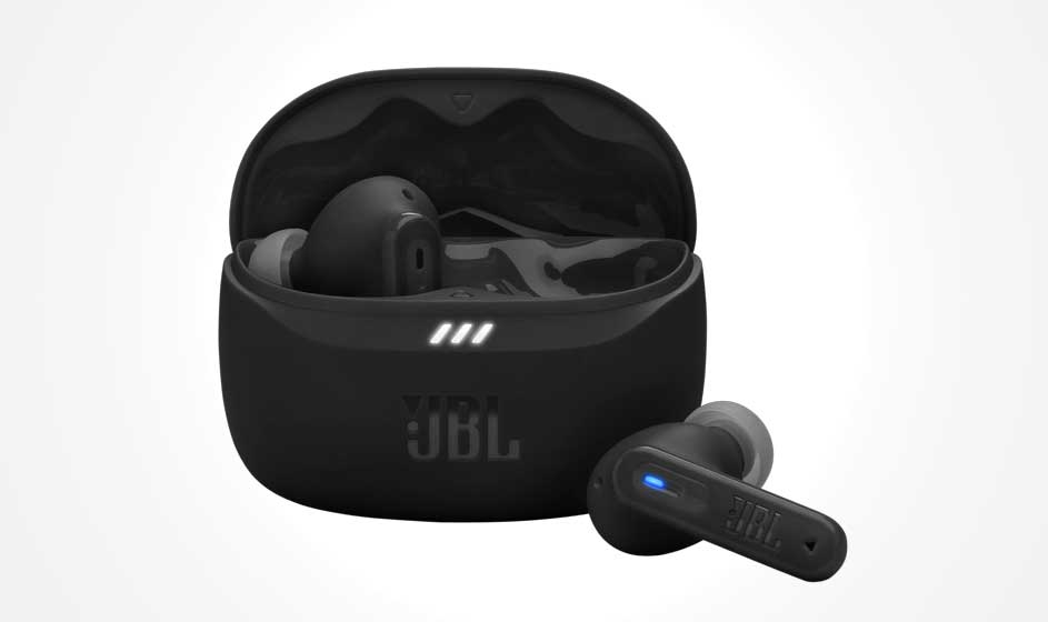A black JBL charging case sits open against a white background. One earbud is inside, while the other rests in front with a glowing blue indicator.