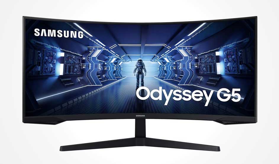 Curved Samsung Odyssey G5 monitor shows a blue sci‑fi corridor with an astronaut centered; big Samsung and Odyssey G5 text on screen.