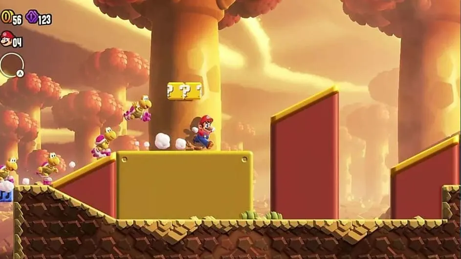 Mario saute sur une plateforme jaune dans un jeu vidéo. Des Koopa Troopas sont visibles. L'arrière-plan est jaune avec des arbres.