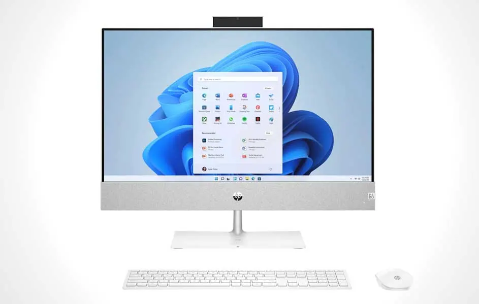 Een witte all-in-one computer met een blauw bloemmotief op het scherm, plus een toetsenbord en muis.