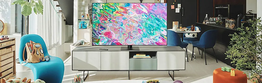 A living room features a TV with colorful graphics, atop a white cabinet. Blue chairs and plants are present.