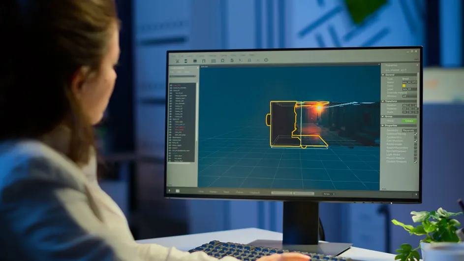 Close-up van een computerscherm met CAD-software, blauwe achtergrond met gele lijnen die een object weergeven, toetsenbord en groene plant.