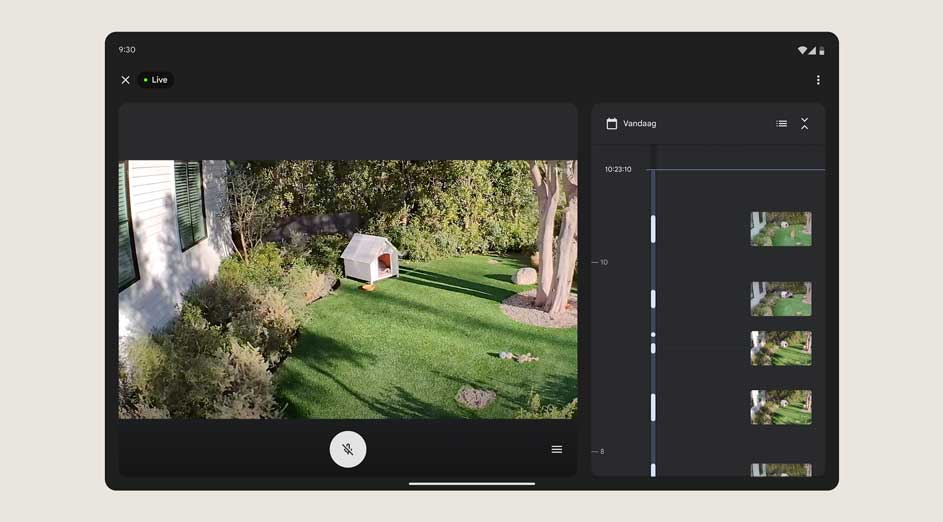 Op een tablet is een live videostream te zien van een groene tuin met een wit hondenokt.