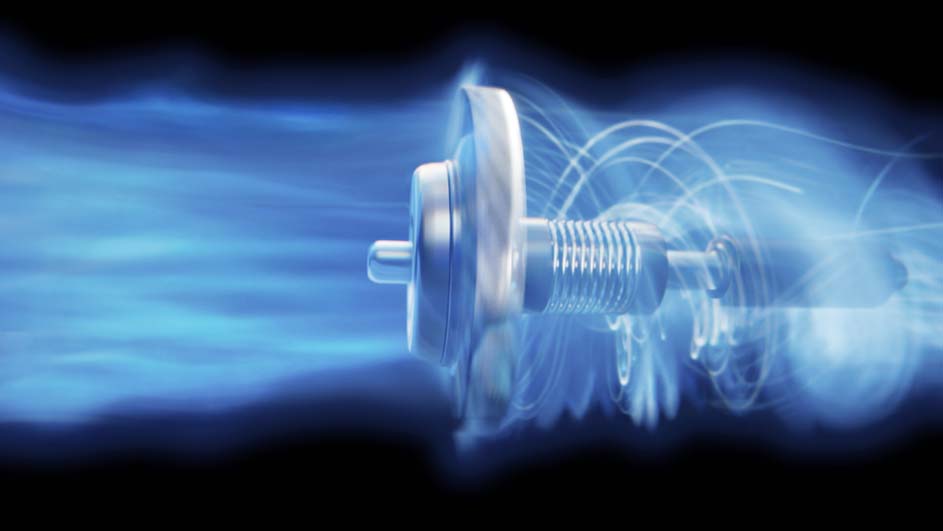 Un appareil argenté avec un ressort, entouré d'une brume bleue sur un fond noir.