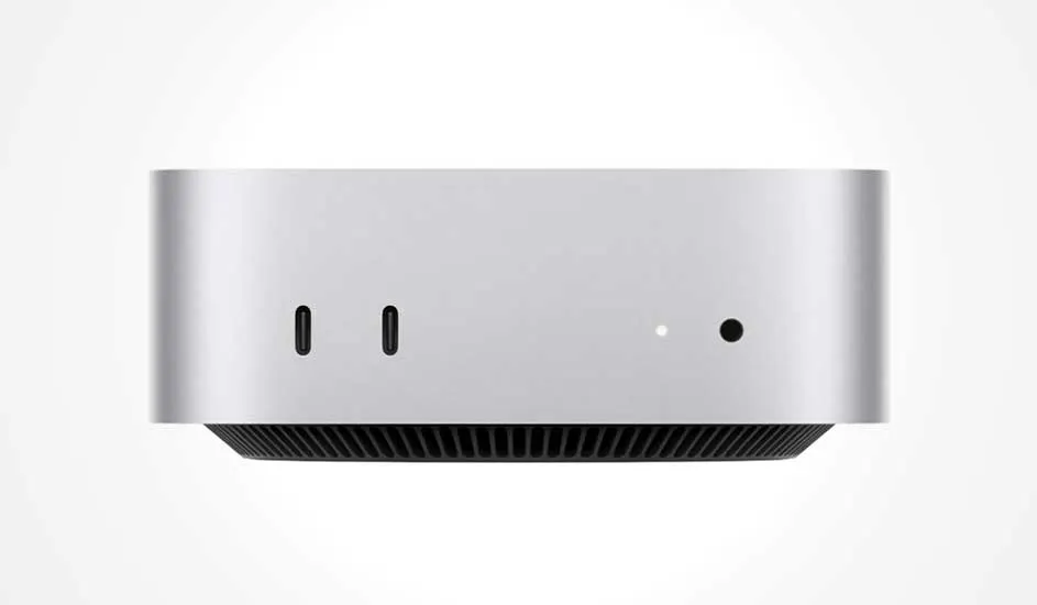 Un ordinateur de bureau compact et argenté avec deux ports USB-C, une petite LED et une prise audio à l’avant.