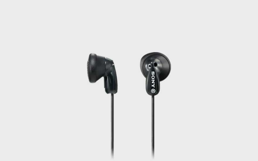 Two classic black Sony wired earbuds with a simple, compact design are shown hanging side by side on a light background.