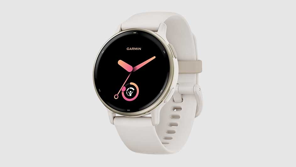 A Garmin watch features a black face with pink hands, surrounded by a light-colored band. The background is a solid, light grey.