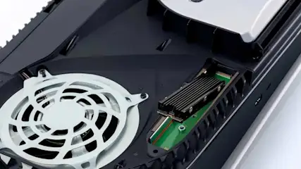 An open PlayStation 5 with a fan and an SSD expansion drive installed, visible in the dedicated slot.