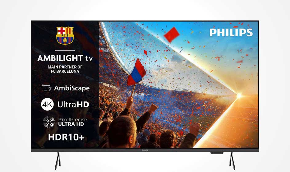 Un téléviseur Philips Ambilight montre un stade plein, des supporters en liesse, des drapeaux, des confettis et un soleil chaud.