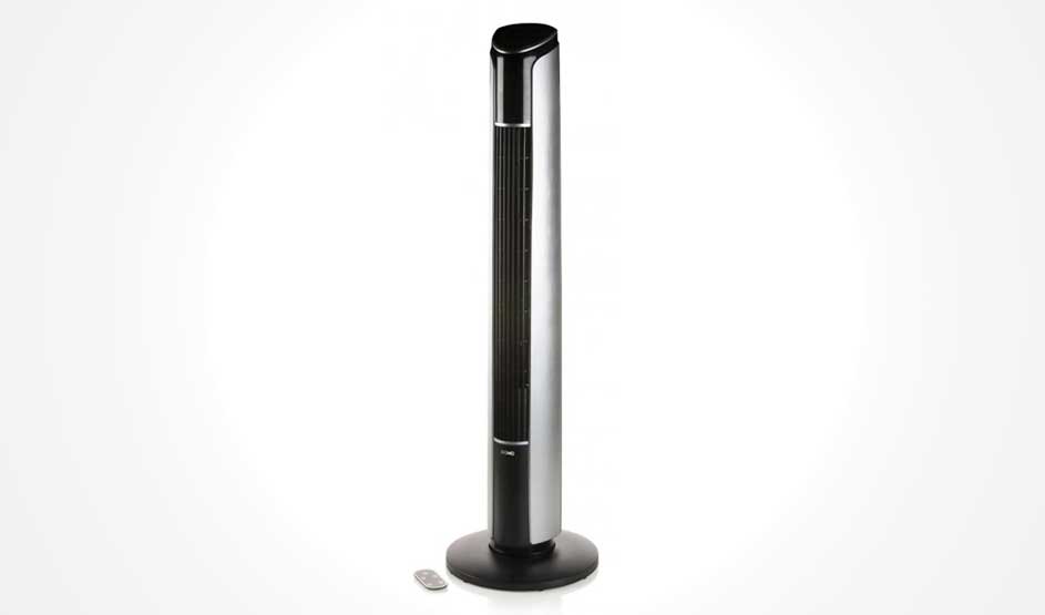 A black tower fan stands against a white background, with a small remote control placed beside it.