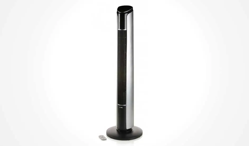 A black tower fan stands against a white background, with a small remote control placed beside it.