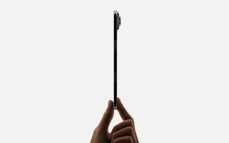 Side view of an ultra‑thin smartphone, held upright between thumb and finger.