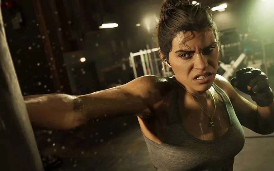Woman training in a gym and punching a heavy bag.