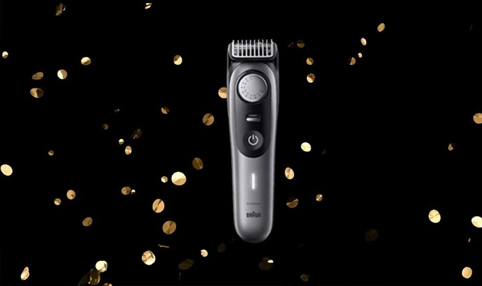 Op de afbeelding staat een zilveren Braun trimmer centraal, met gouden confetti op een zwarte achtergrond voor een feestelijk effect.