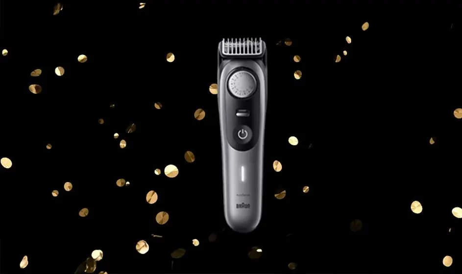 Op de afbeelding staat een zilveren Braun trimmer centraal, met gouden confetti op een zwarte achtergrond voor een feestelijk effect.