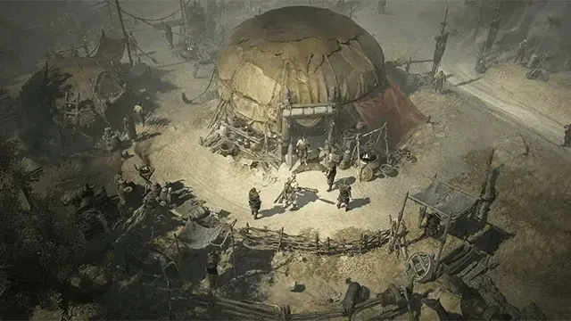 Vue aérienne d'un village désertique avec une grande structure en forme de crâne. Des personnes se tiennent près de l'entrée.