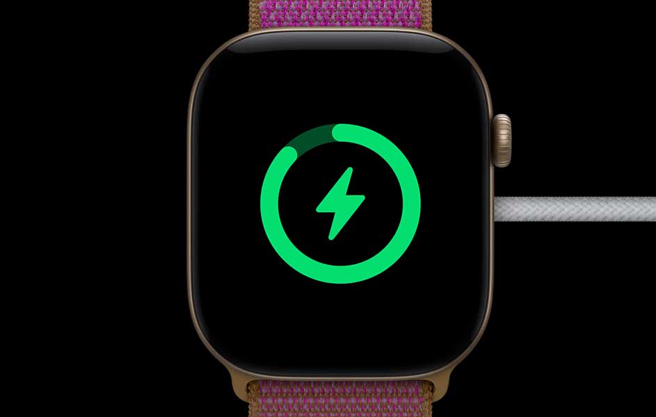 Een smartwatch met een roze gevlochten band staat centraal tegen een zwarte achtergrond. Op het scherm verschijnt een helder groen bliksemsymbool in een cirkel.