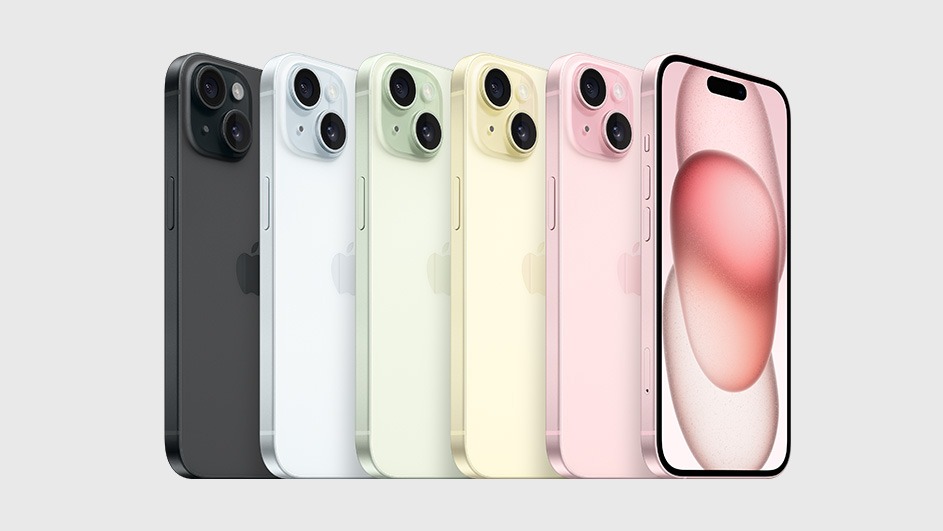 Cinq iPhones alignés : noir, blanc, vert clair, jaune clair et rose. L'écran du téléphone rose est allumé. Fond gris clair.