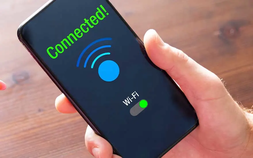 Gros plan sur un smartphone affichant « Connected! », un grand symbole Wi Fi bleu et un interrupteur vert confirmant la connexion sans fil.