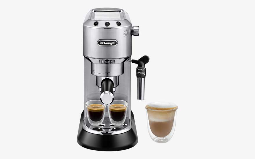 A silver De’Longhi espresso machine pours two espressos, with a steam wand and a separate glass cup filled with foamy milk.