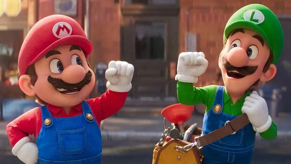 Mario, in red, and Luigi, in green, wear blue overalls and white gloves, raising fists in front of a brownstone building.