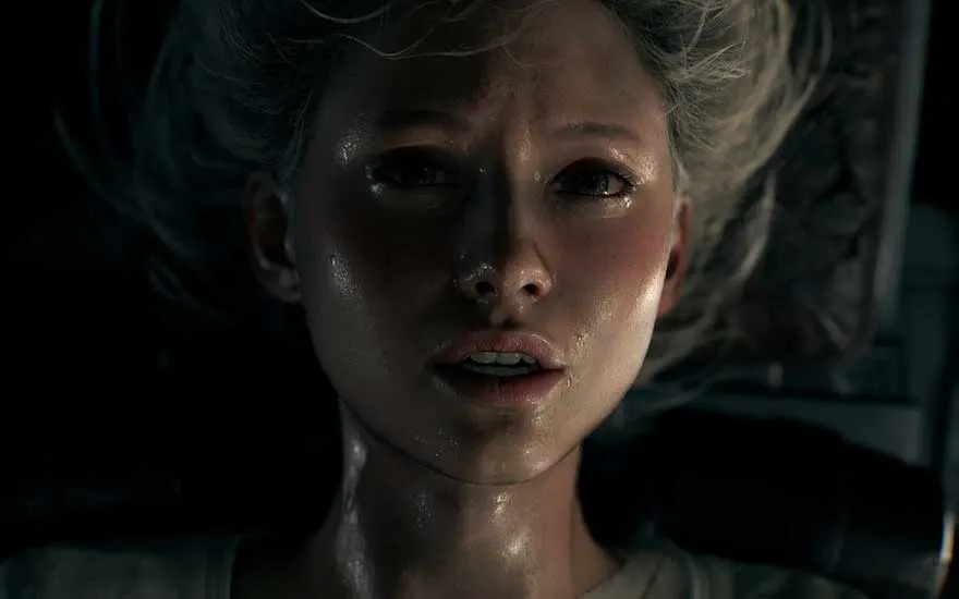 This is a video game. Close-up of a sweaty woman lying down, eyes wide with fear; harsh light cuts through shadows across her face.