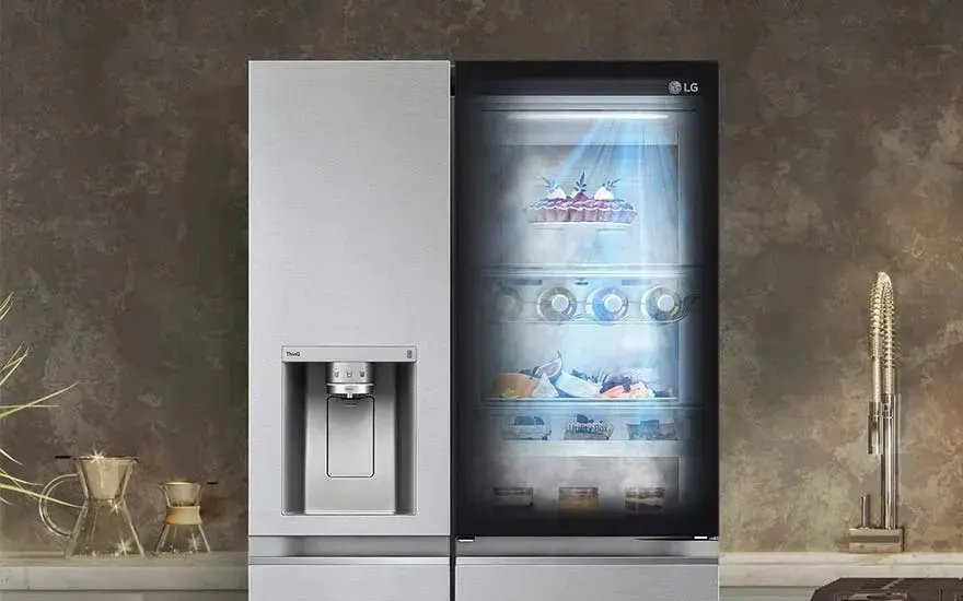 Modern LG refrigerator with double doors, glass viewing panel and water dispenser. Filled with food, illuminated and stylish in design.